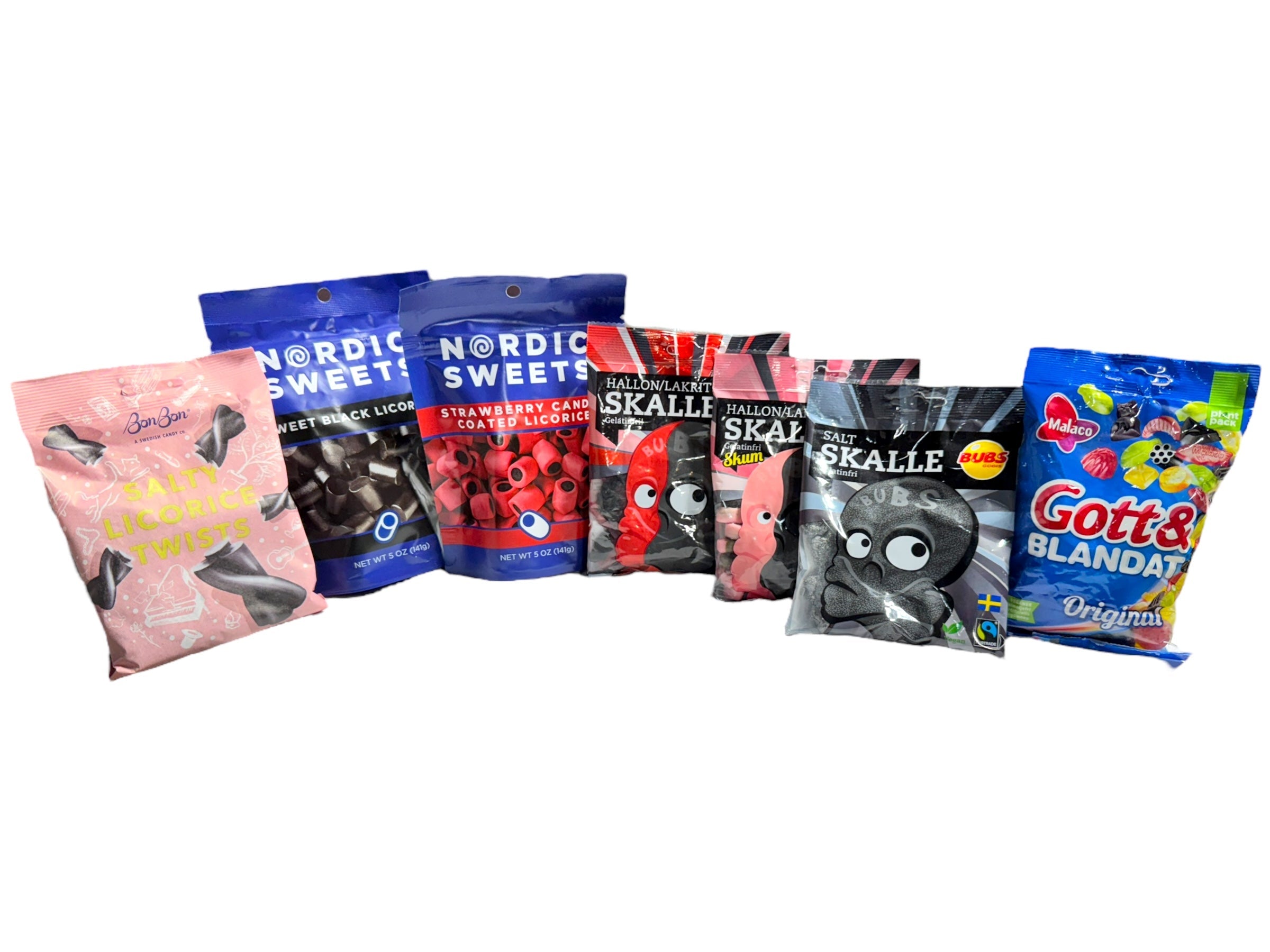 Packets of Nordic candies, including different varieties of licorice and a bag of assorted sweets, arranged in a row.