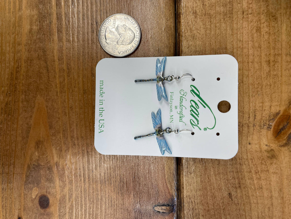 Earrings: Aqua Dragonfly Earrings with sterling silver ear-wires are shown on a card next to a U.S. quarter for scale, placed on a wooden surface.