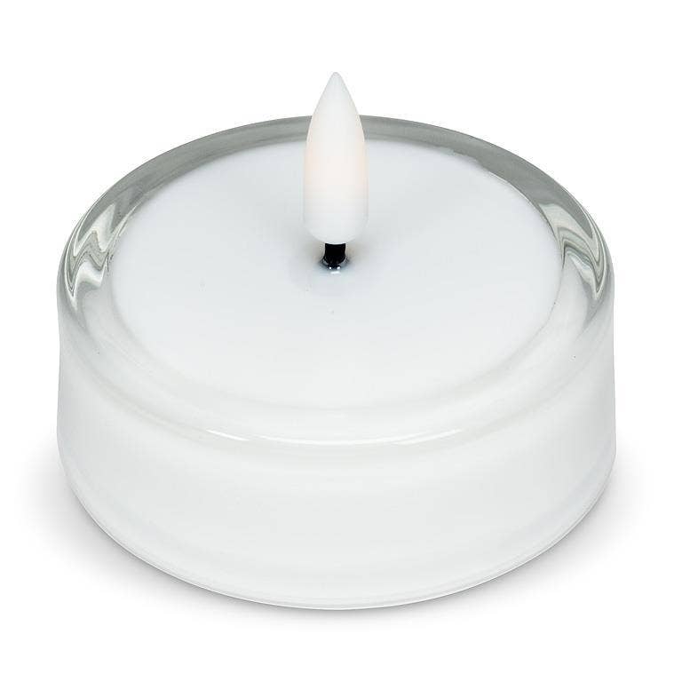 White LED tea light with a flickering flame inside a clear glass Maxilight holder.