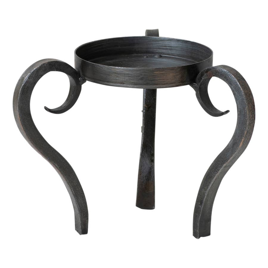 The Candle Holder: Raised Wrought Iron Ball Candle Holder is a small, round, black wrought iron table with three curved legs and a raised edge around the tabletop.