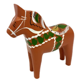 The "Dala Horse: Orange Dala Horse Old Red" is a charming example of Swedish traditional craftsmanship, showcasing exquisite orange paint adorned with intricate green, white, and gold designs, set gracefully against a white backdrop.