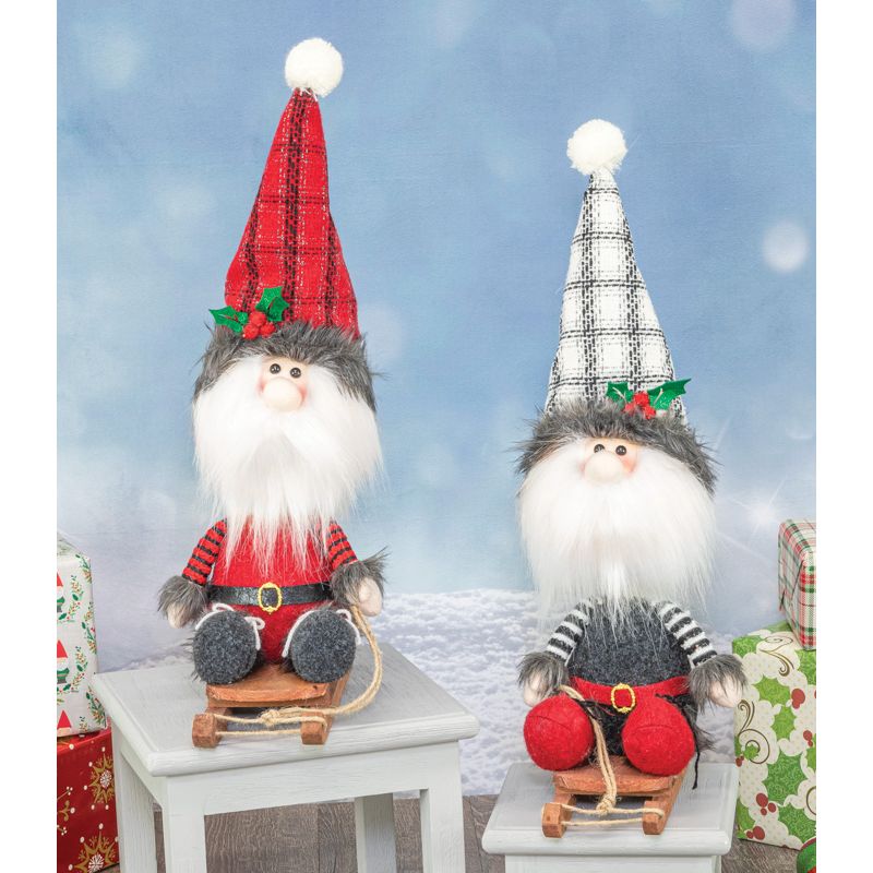The Decoration: Stylish Santa Sledder features charming gnome dolls and a Santa bobble head on sleds, displayed with wrapped gifts against a snowy backdrop—ideal for creating a festive Christmas display.