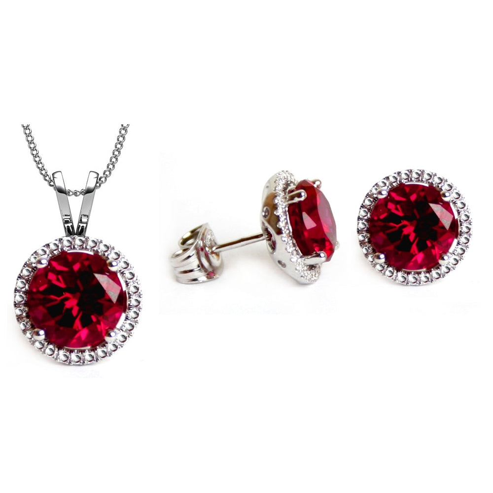 Handmade solitaire stud earrings featuring a Ruby Red Swarovski Crystal, accented by small clear stones and set in silver metal.