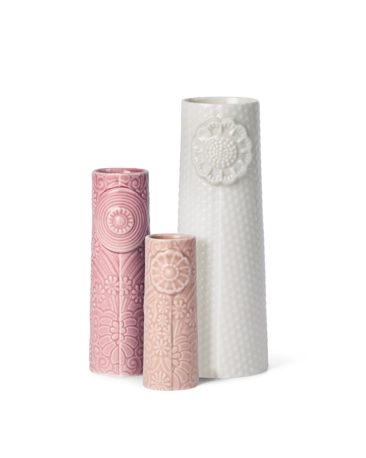 Three Nordic ceramic vases in rose, pink, and white, featuring embossed floral patterns and a textured dot motif.