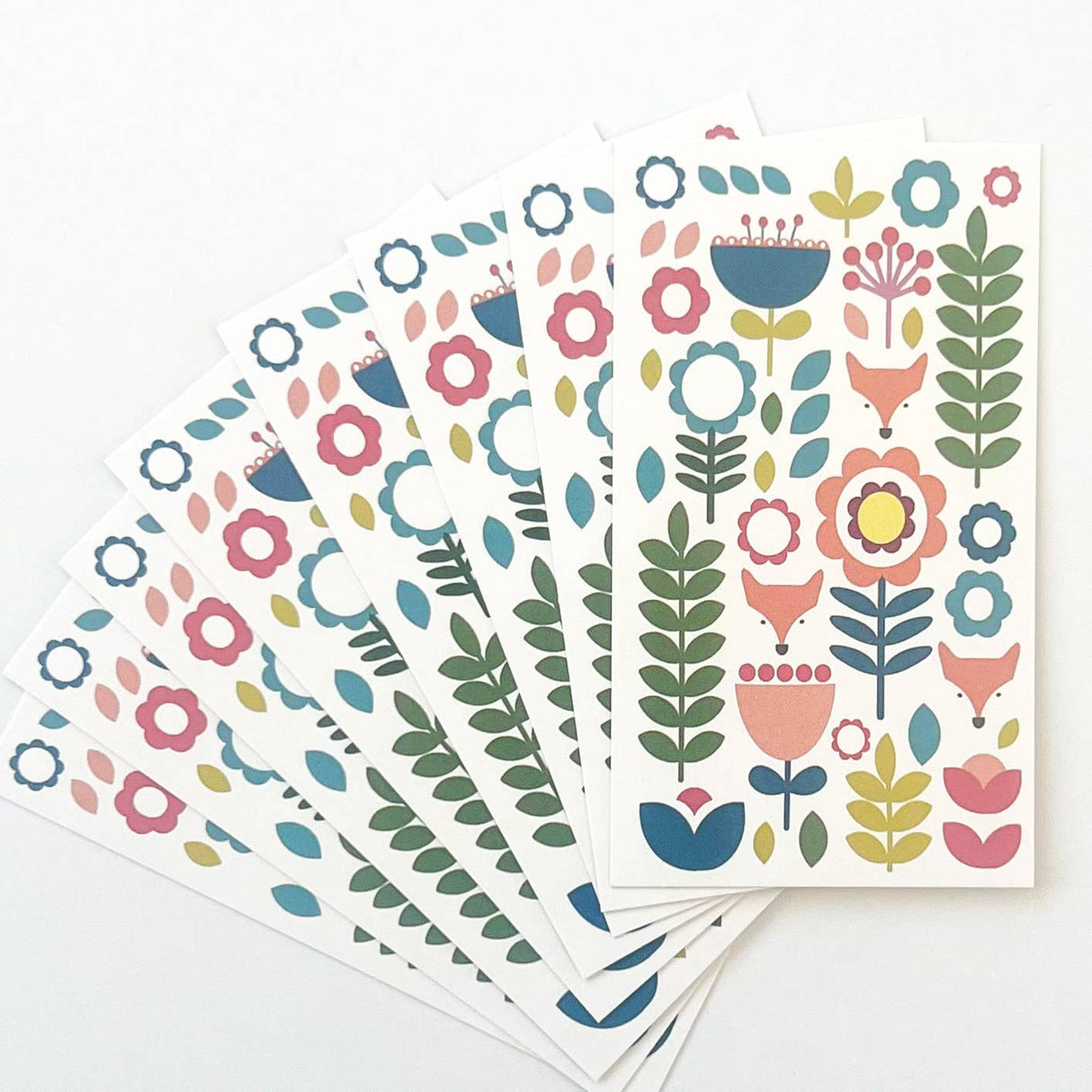 Juniper Blue's "Tuli" set includes 8 Scandinavian folk-art gift tags (2"x3.5") with envelopes, each featuring colorful fox and floral designs inspired by Scandinavian style.