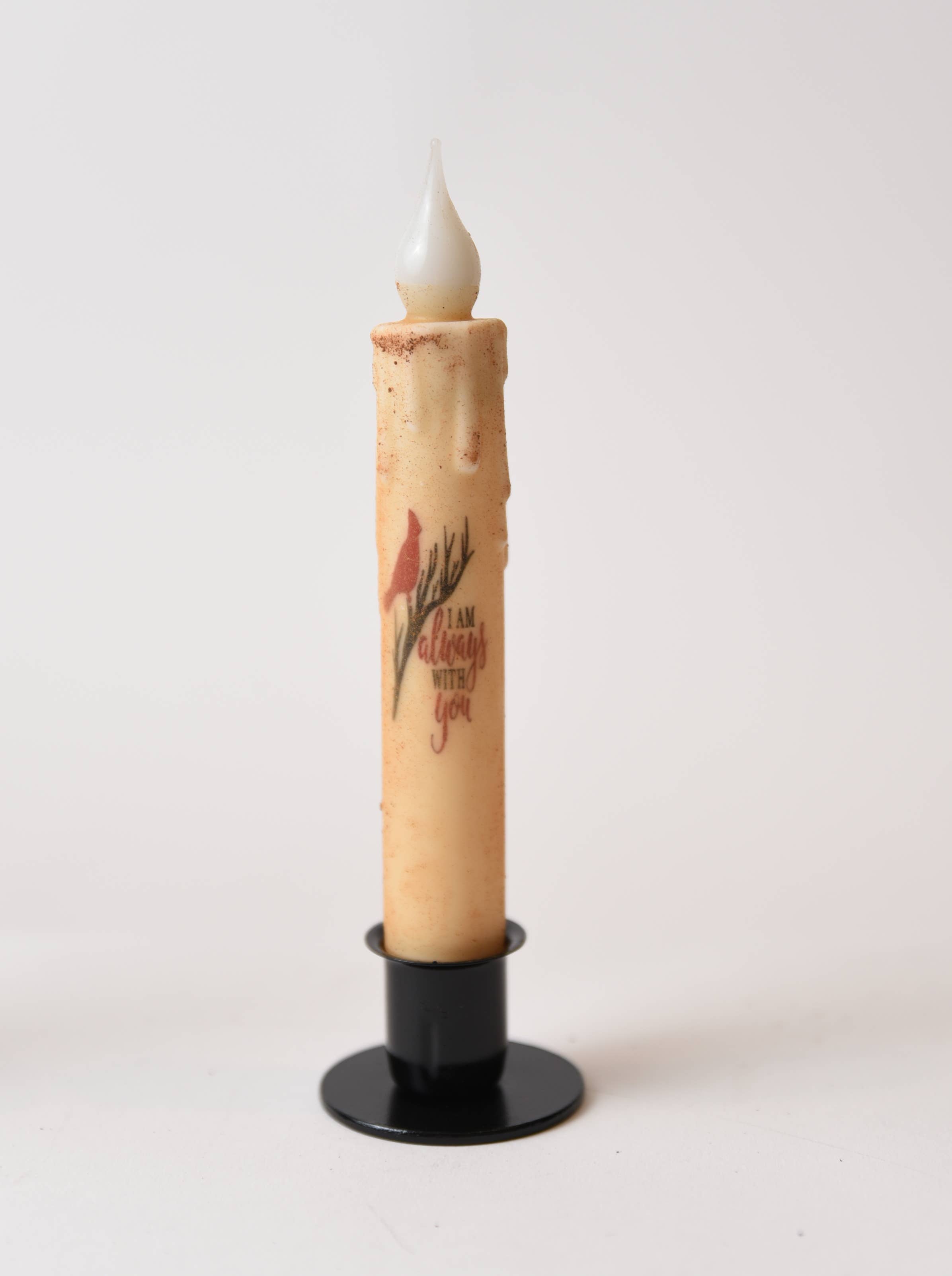 The Candle: I am Always with You Cardinal LED Timer Taper Candle: Cinnamon Dusted features a faux flame, floral design, and sentimental text in a black holder—ideal for farmhouse décor.