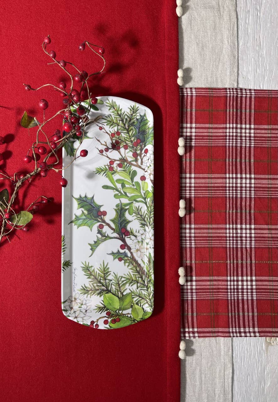 The Tray: Holly & Berries Holiday Serving Appetizer, Almond Cake, Bread Loaf Tray features a festive holly and berry design and sits on a red tablecloth beside a red plaid napkin and holiday decor with red berries.