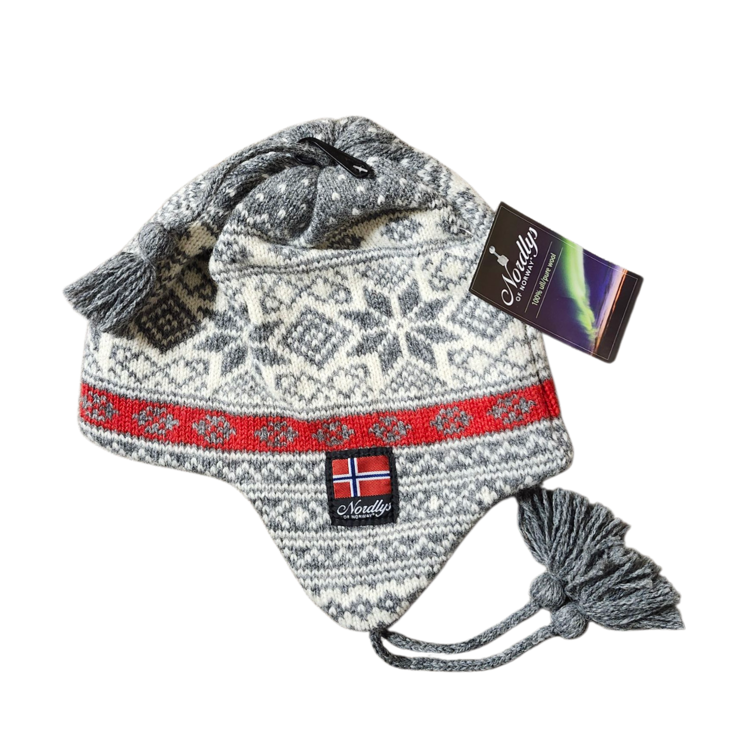 The Norwegian Selbu Star Wool Knit Earflap Hat (Lt Grey/Red) features gray and white Nordic star patterns, red accents, tassels, a Norway flag patch, and comes with an attached product tag.