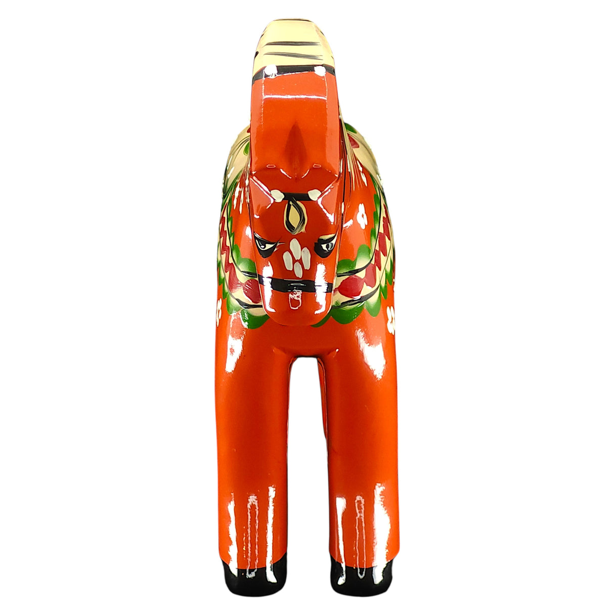 A hand-carved, red Färnäshästen Dala Horse by Nils Olsson (14 cm/5.5 in) features four legs, a flat snout, upright ears, and floral motifs—showcasing the iconic Swedish design when viewed from the front.
