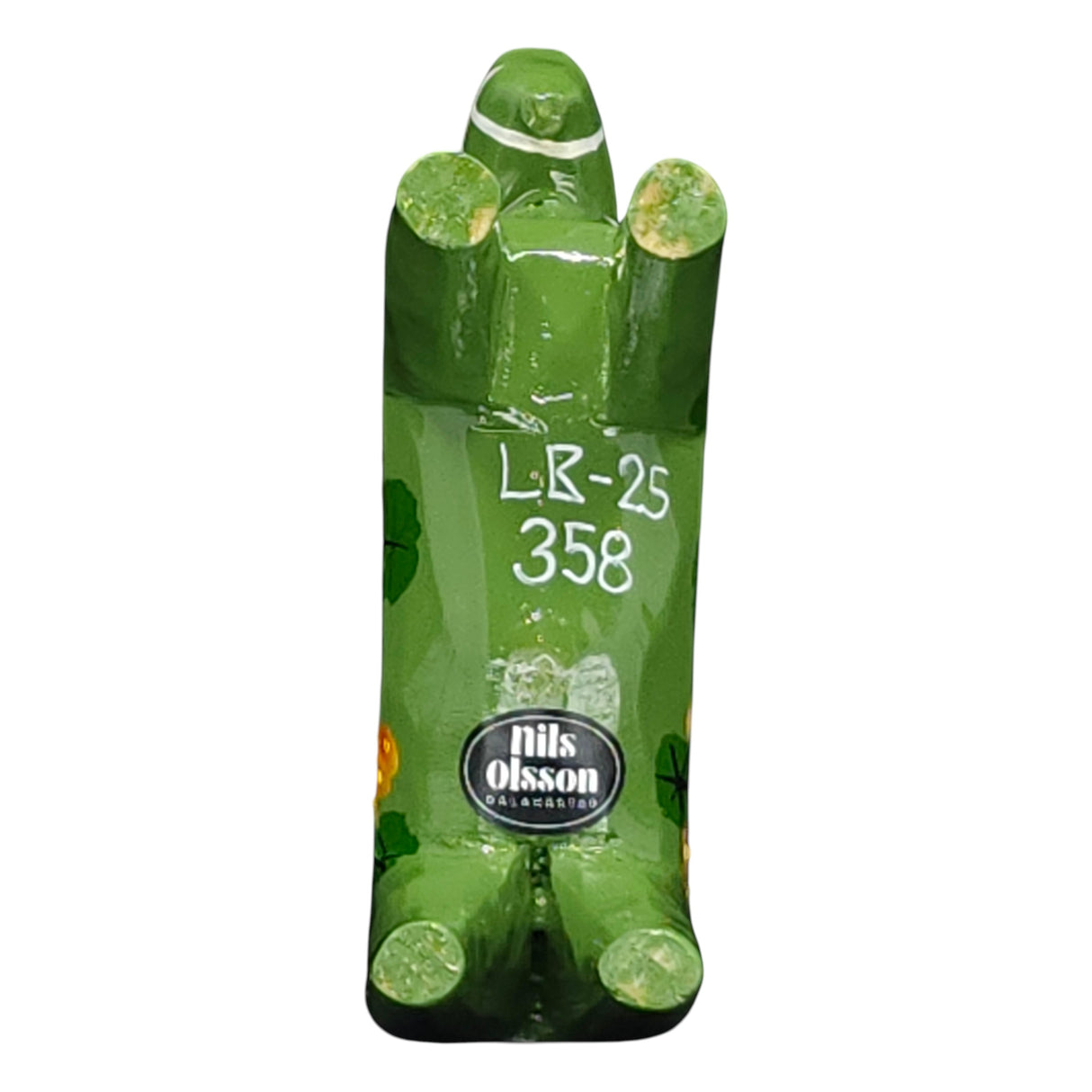 The Dala Horse: Salenhasten 13cm (5" tall) is a green, hand-painted wooden figurine. Viewed from below, it shows Swedish craftsmanship with visible LR-25 358 and the Nils Olsson label, exemplifying traditional artistry.