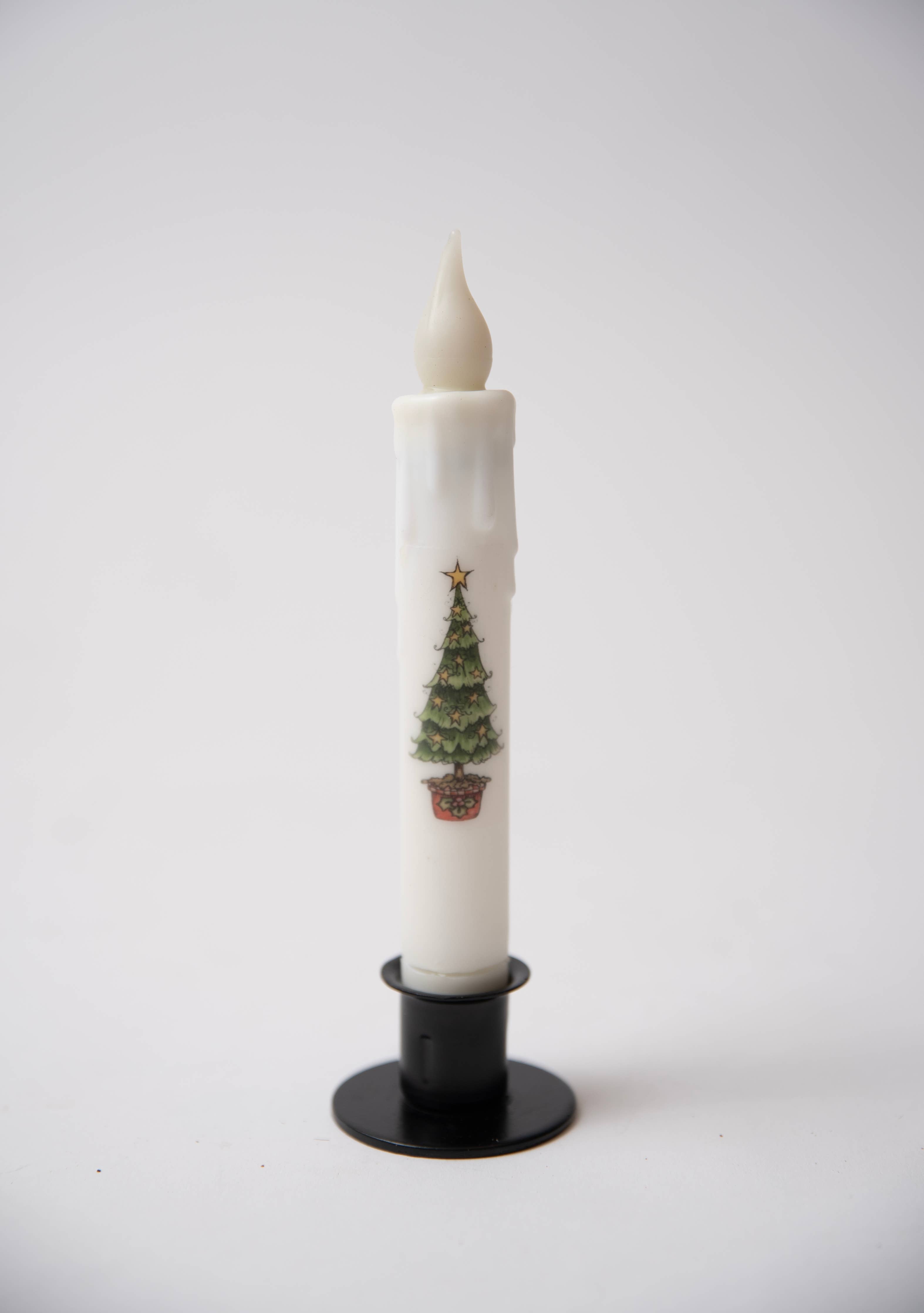 The Candle: Grinch Tree LED Timer Taper Candle (White) stands upright in a black holder against a plain white background.
