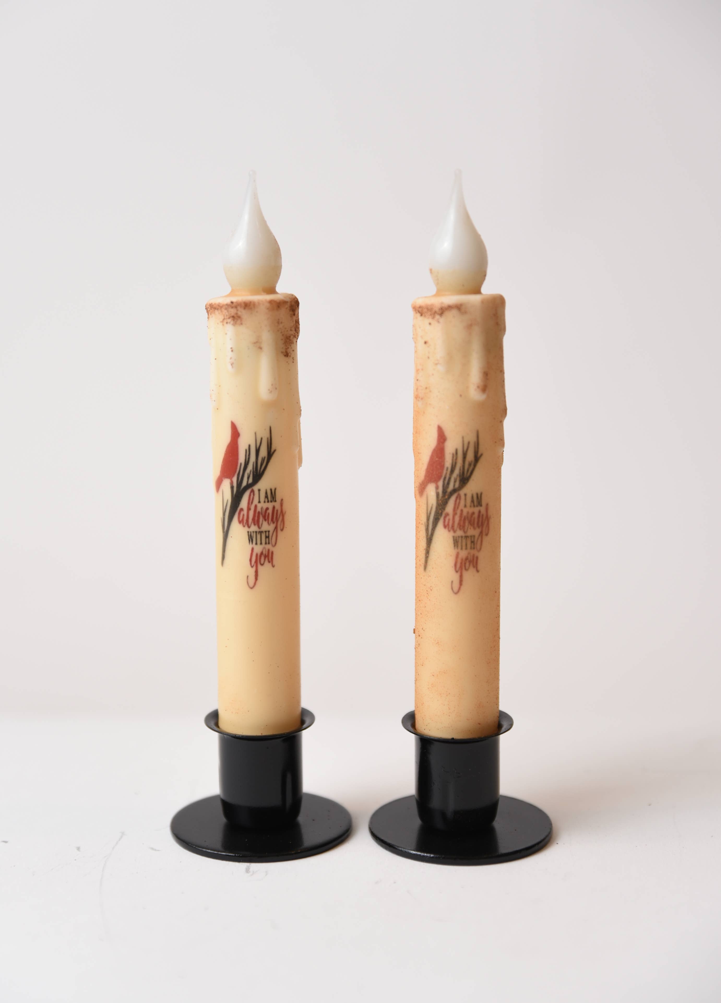 The "I am Always with You Cardinal" LED Timer Taper Candles feature faux wax drips, black bases, cinnamon dusting, a red cardinal design, and heartfelt text—perfect battery-operated accents for farmhouse décor.