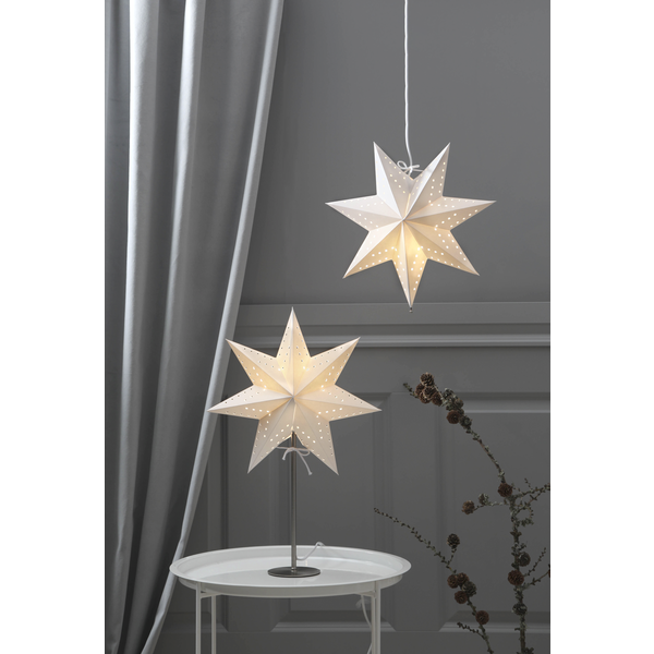 The Star Trading Bobo Star White table and hanging lamps softly illuminate the space, set against a gray wall with a silver curtain and a round white table.