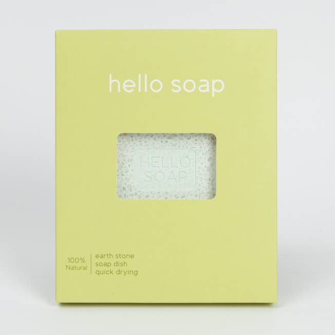 A green box labeled Hello Soap holds a visible white Kalastyle Home Green Diatomite Soap Dish (4 x 4). The box states its 100% natural, made from earth stone, and quick drying.