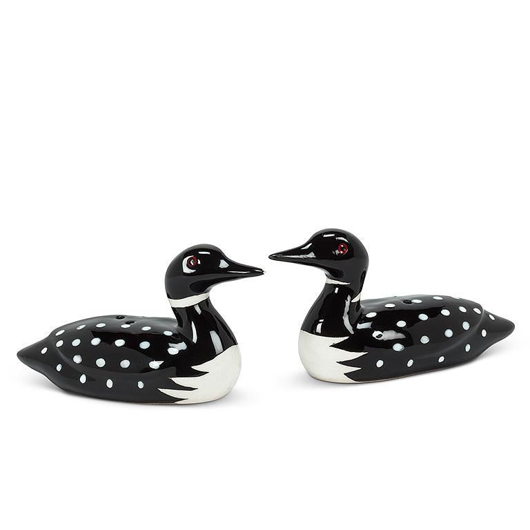 Two ceramic loons, black and white with spotted patterns, from the Shaker: Salt & Pepper Shaker - Loons set, face each other on a plain white background.