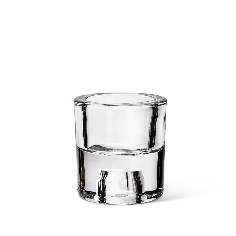 A 2.5" glass reversible taper/tealight holder, which resembles a clear shot glass, is elegantly displayed on a white background.