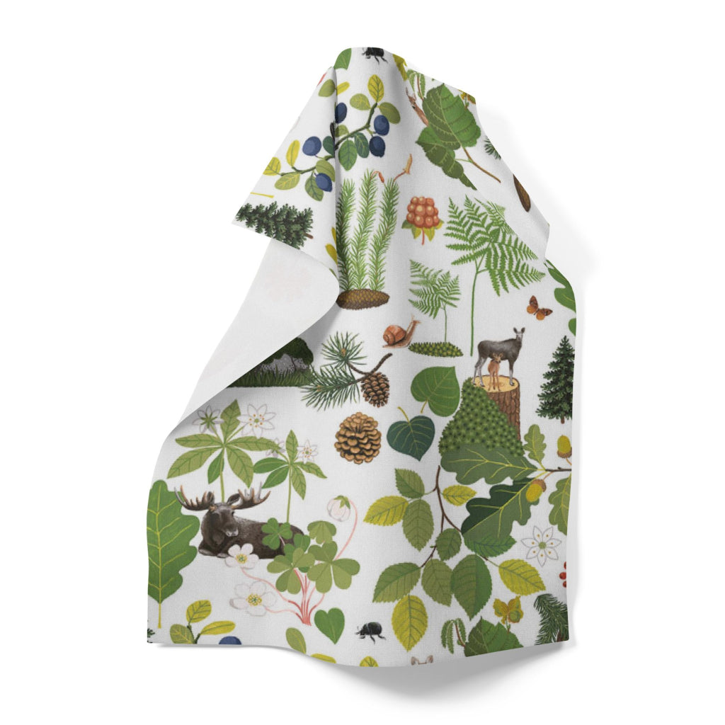 The Skogsliv Forest Life Tea Towel by Arvidssons Textil of Sweden (18" x 27") features forest plants, leaves, berries, pinecones, mushrooms, and animals like a moose and bear on a white background.