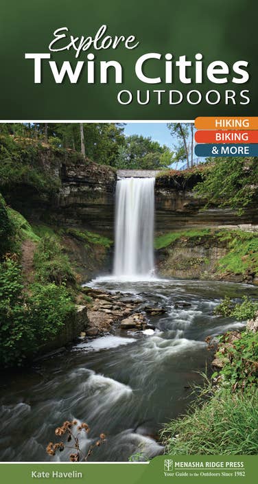 Cover of "Book: Explore Twin Cities Outdoors Quick Guide," featuring a waterfall in a lush forest setting, with text highlighting the opportunities for hiking and biking through stunning outdoor locations.