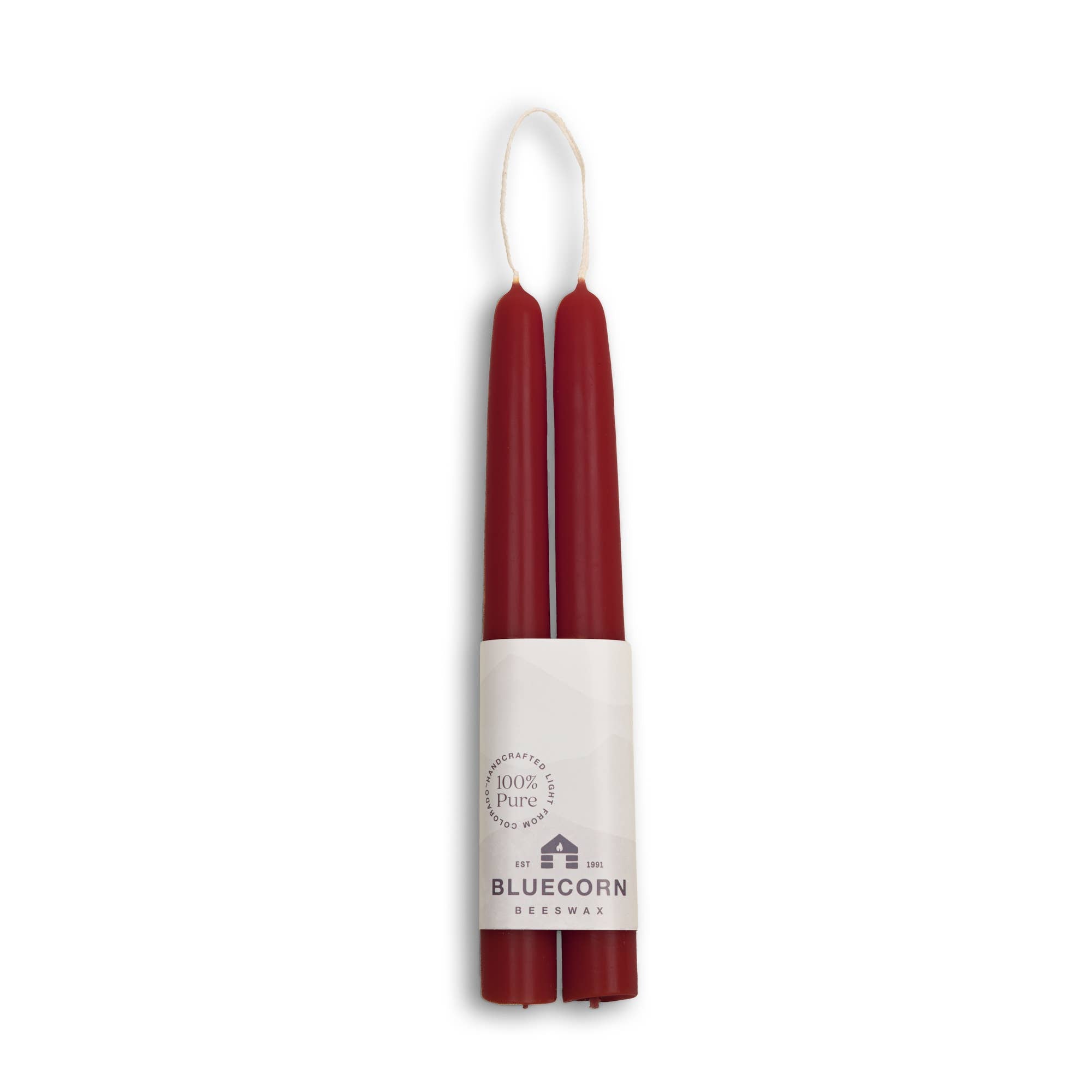 A duo of red, eco-friendly beeswax taper candles with a white paper label at the base, marked Candles: Beeswax Taper Candles – Eco-Friendly, Dripless & Handmade: 2 - 10 Candles.