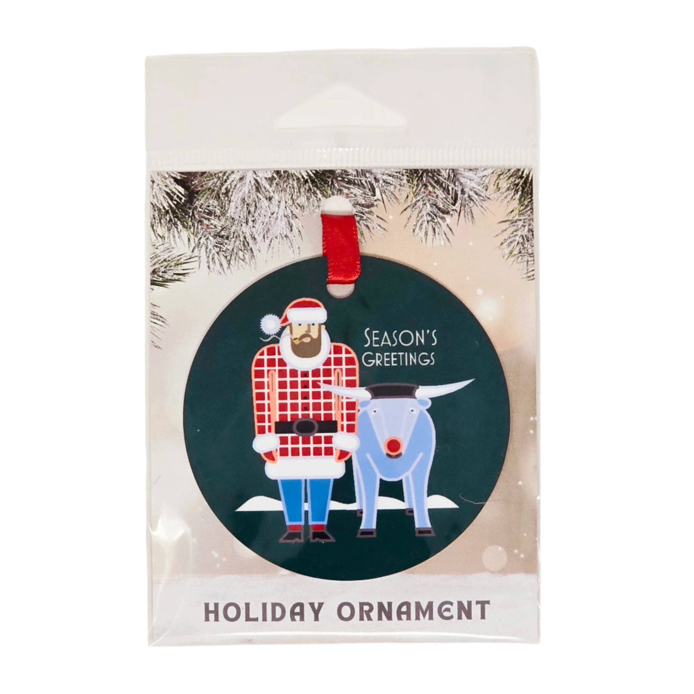 The Nordic Love Metal Ornament, featuring artwork by Cindy Lindgren, is a delightful holiday decoration. The packaging showcases an illustration of Santa in a plaid outfit alongside a blue reindeer, embodying the charming Scandinavian style. The ornament is adorned with "Seasons Greetings" text on a green background, making it a cheerful addition to any Christmas tree.