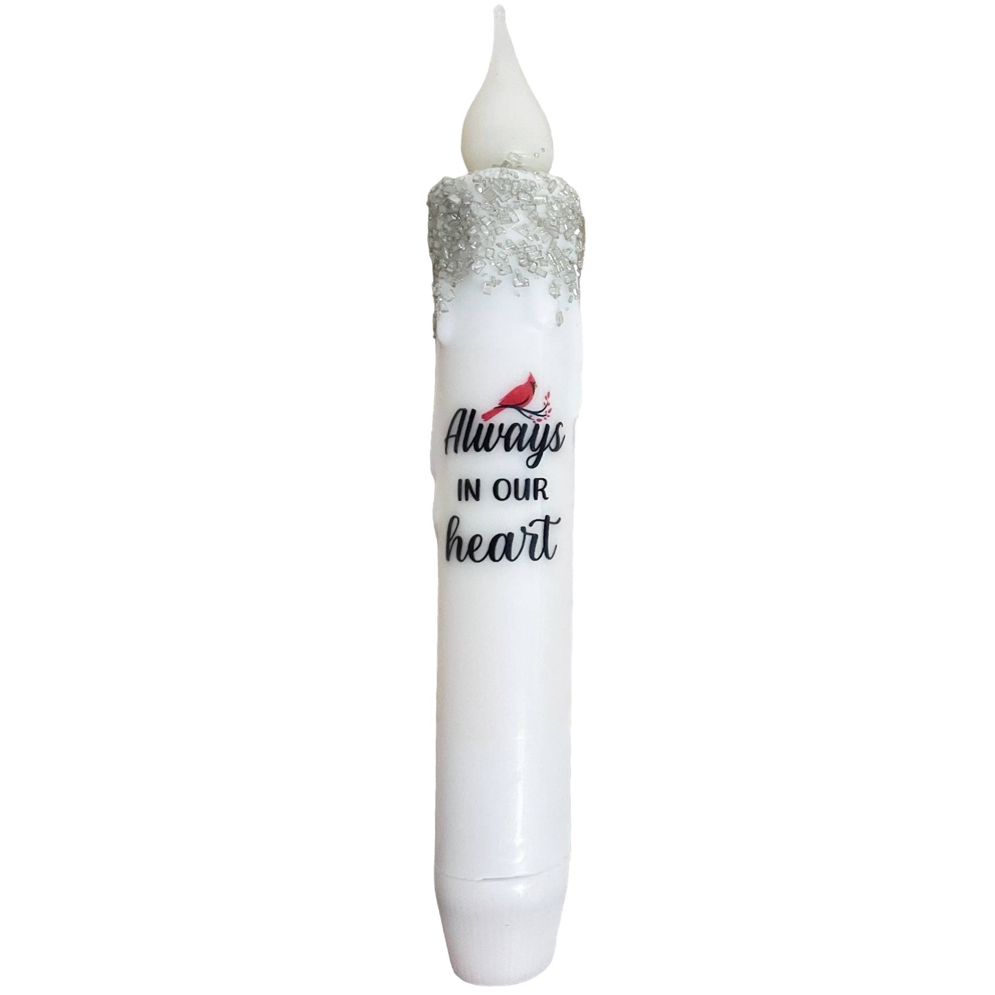 The Candle: Cardinal Memorial Always in our Heart LED Battery Operated Timer Taper Candle features a glittery white design with a red bird illustration, offering a touching memorial gift that provides a warm glow safely through its convenient timer function.