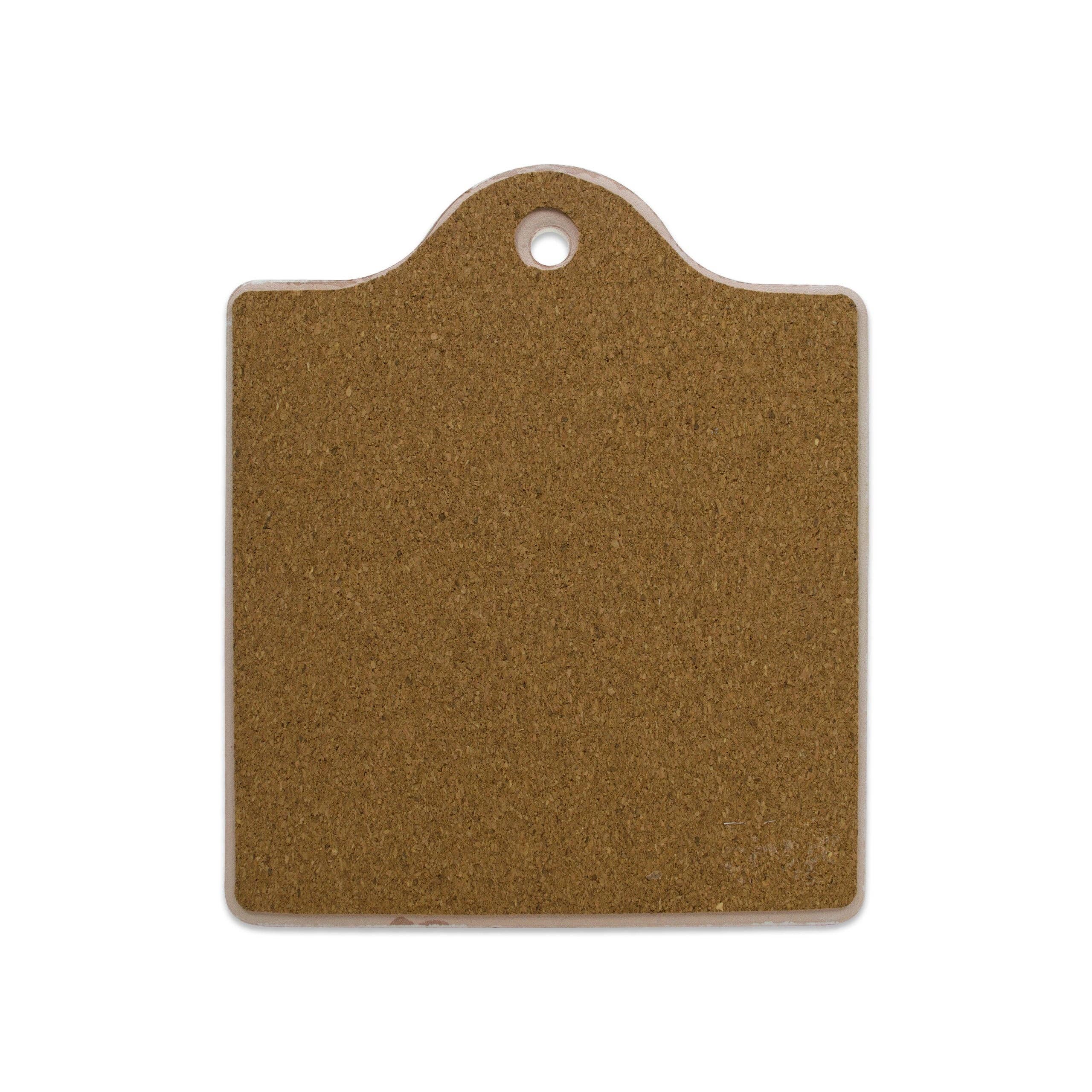 The Tile: Scandinavian House Rules Cork Backed Ceramic Cheeseboard, with a rounded top and small hole for hanging, adds charm to any kitchen decor.