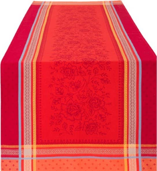 A red "Bouquet" tea towel made of 100% woven cotton with traditional jacquard floral patterns and multicolored striped edges in a classic Provençal style, measuring 20"x28".