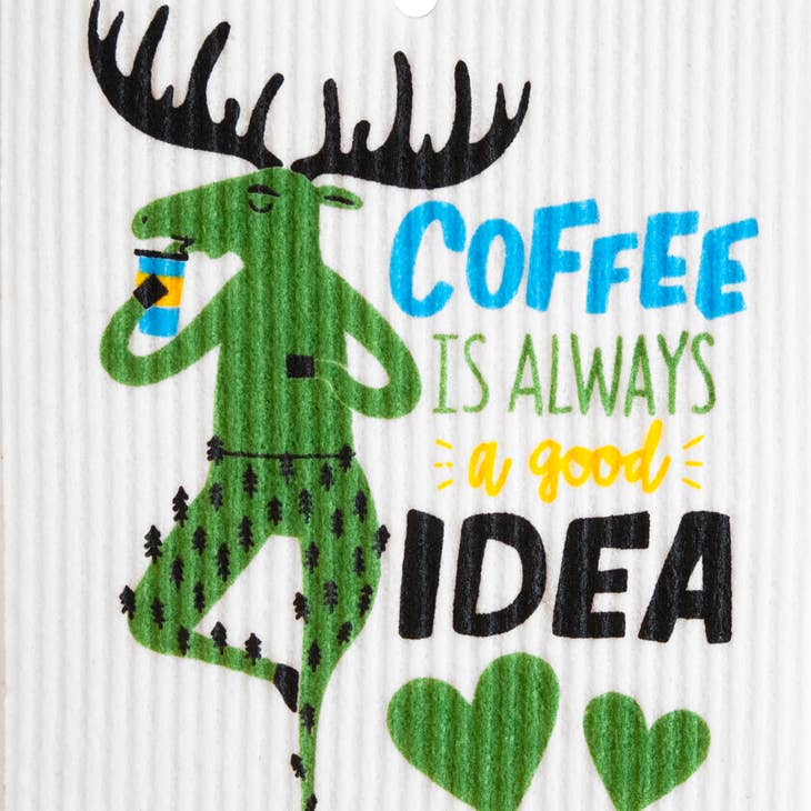 The "Dish Cloth: Coffee is Always a Good Idea - Moose Drinking Coffee" features a green moose in tree-patterned pants with coffee, two green hearts below, and the phrase—ideal for eco-friendly kitchens or Swedish dish cloths.