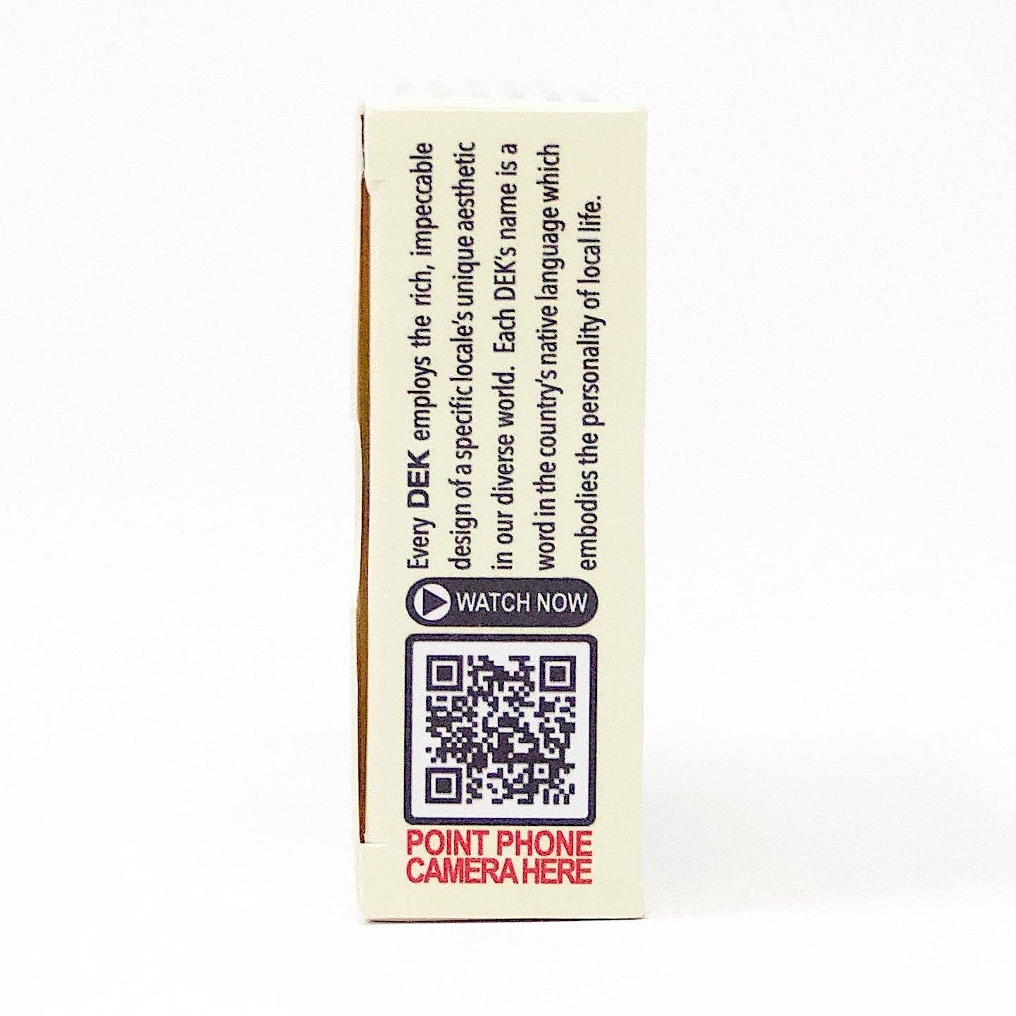 Side view of a box of Playing Cards: DEK Lykke (Denmark) showcasing text and a QR code that invites you to scan with your phone camera for an instant dose of happiness. Tap the Watch Now button, and immerse yourself in the Lykke experience!