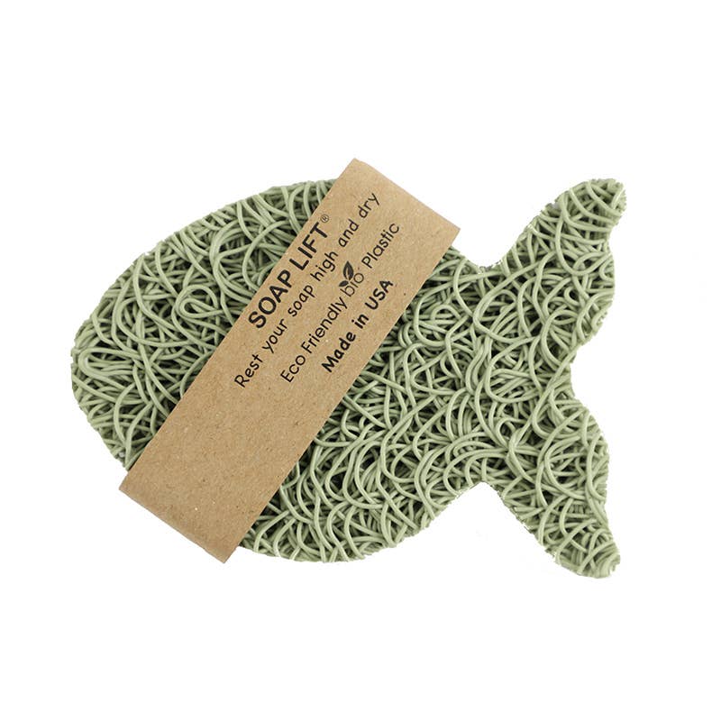 The Soap Lift: Soap Saver Fish is crafted from eco-friendly bioplastic and features an attached label detailing its purpose and origin.
