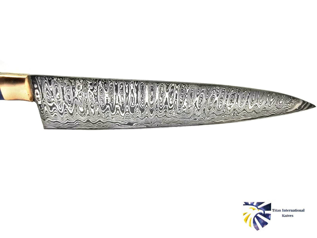 The Damascus Chef Knife by Titan International Knives features a hand-forged, patterned Damascus steel blade and a wooden handle, showcased on a white background with the brand's logo visible.