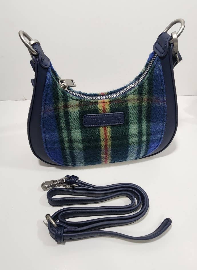The Bag: Tartan Merino Wool Bag - Nova Scotia, featuring dark blue accents, a silver zipper, and a matching detachable strap, is displayed in front, blending classic style with Nova Scotia’s provincial tartan charm.