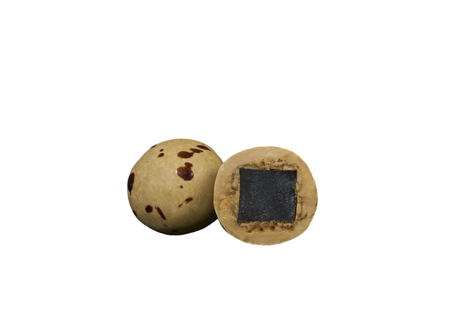 A whole and a halved Candy: Lakrids by Bulow - Crispy Caramel Danish Chocolate Coated Licorice (125g) show brown-spotted shells; the halved piece reveals a dark licorice core encased in chocolate and caramel.