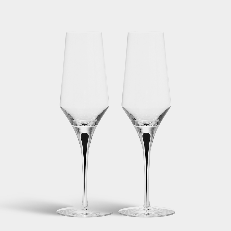 Two empty Orrefors Metropol Champagne Glass 9oz flutes stand side by side on a plain white background.