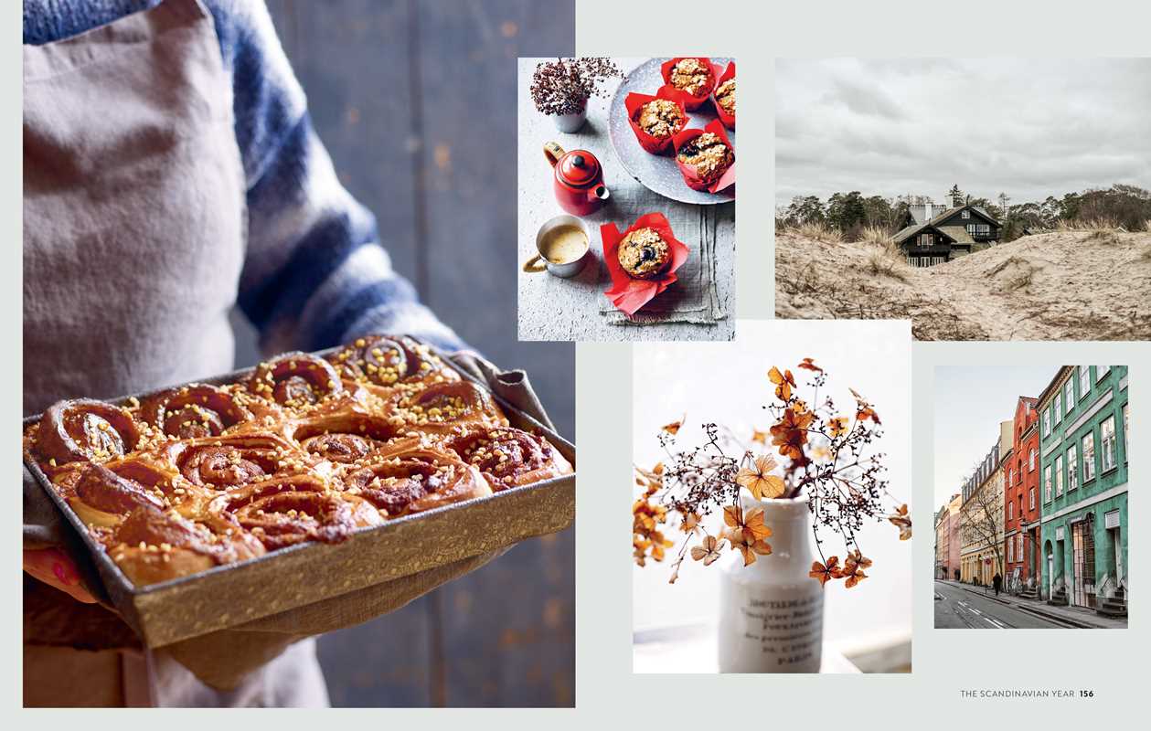 A person holds a tray of cinnamon rolls; nearby are photos of baked goods, dried flowers in a vase, colorful street buildings, and the book "Scandinavian Year by Bronte Aurell: Food and Thoughts from Sweden, Denmark and Norway.