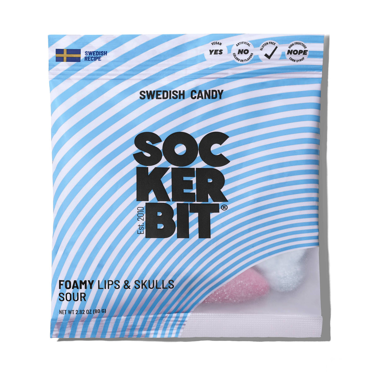 A 2.8oz Sockerbit bag of Foamy Lips & Skulls Swedish Candy with blue and white stripes, a Swedish flag, and pink and white foamy candies visible inside. Made with a traditional recipe.