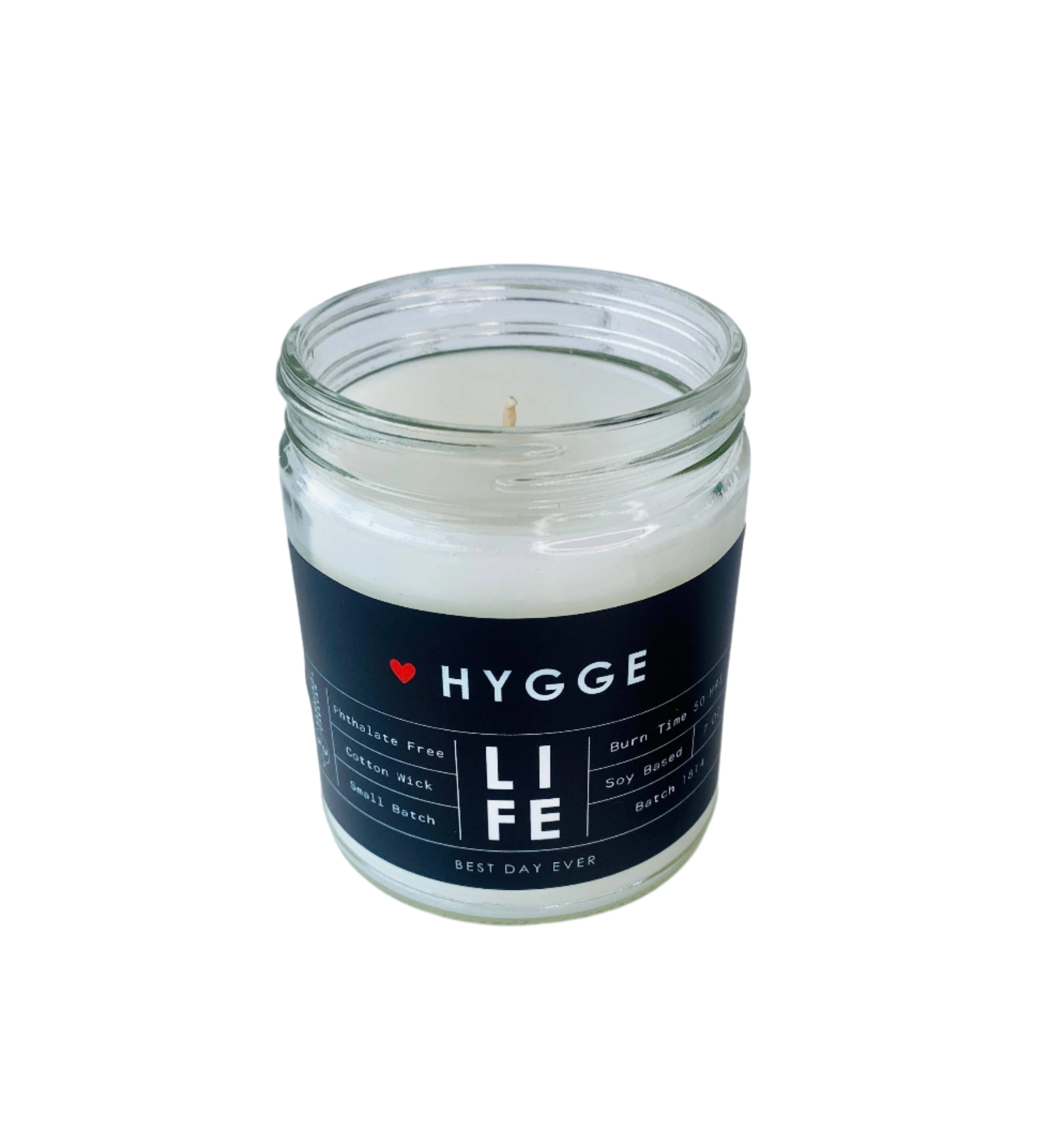 A clear glass jar Candle: Hygge (Danish for comfort) with a black label, crafted from soy coconut wax, featuring a Sea Salt & Orchid scent and the phrase Best Day Ever at the bottom.