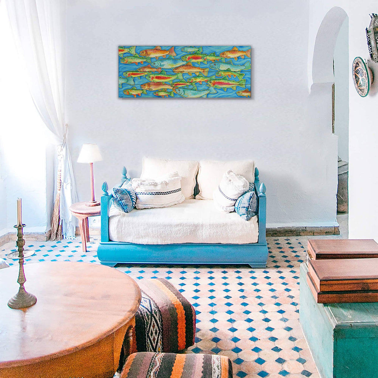 A bright living room with a blue and white palette, patterned tile floor, blue sofa, wooden table, and "Rush Hour - Wood Art" (36" x 14") wall decor displayed among fish-themed pieces.