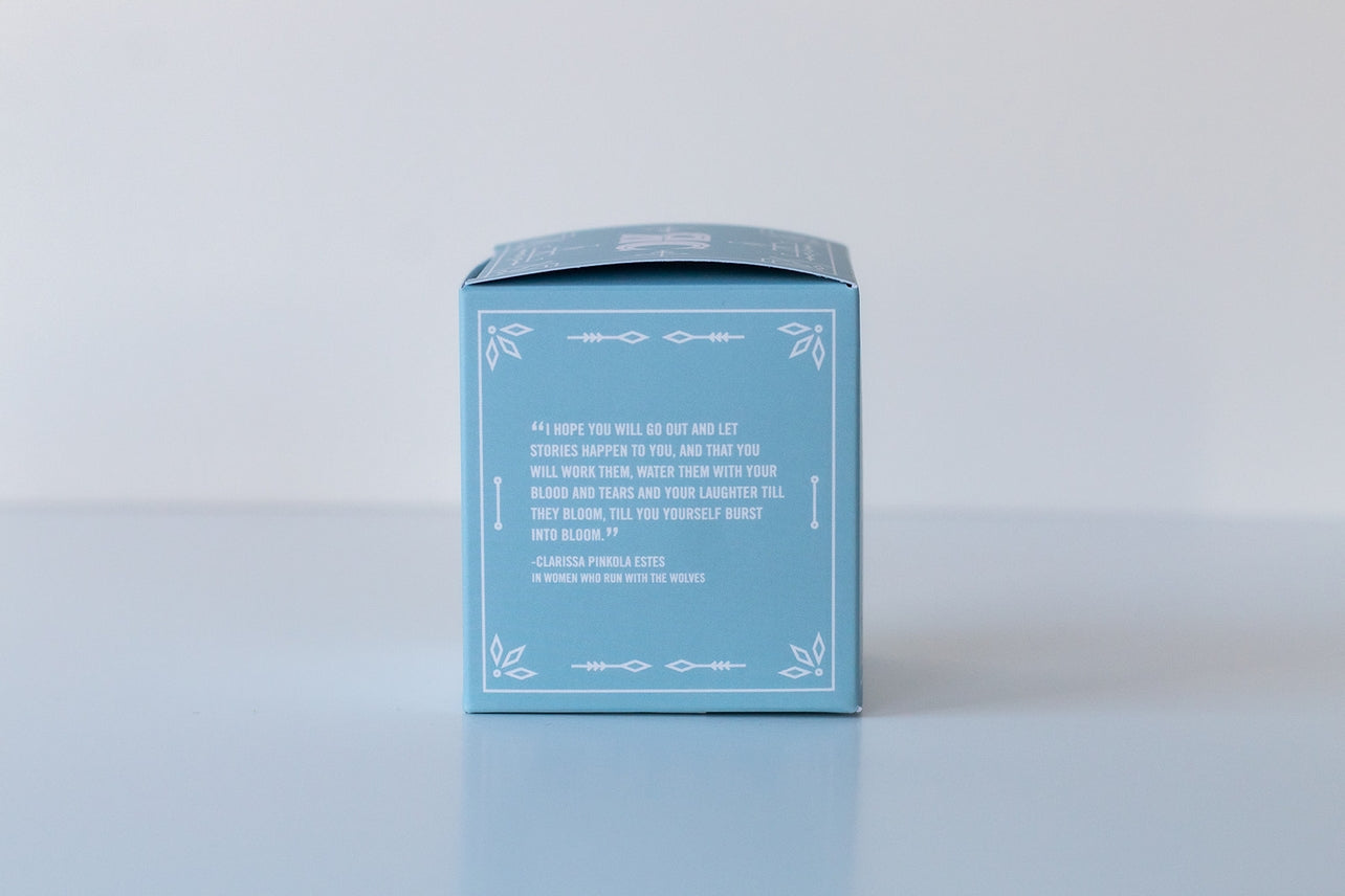 A pastel blue box with a white border and centered quote showcases the Bath Bomb: Coastal Vibes—handmade in the USA—against a simple background, creating an ideal presentation for this luxurious self-care treat.
