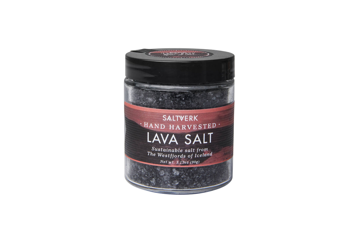 A clear glass jar from the SALTVERK Gift Set, labeled with one of four Icelandic salts—Flaky Sea Salt, Lava Salt, Birch Smoked Salt, or Arctic Thyme Salt—each hand harvested in the Westfjords and topped with a black screw lid.