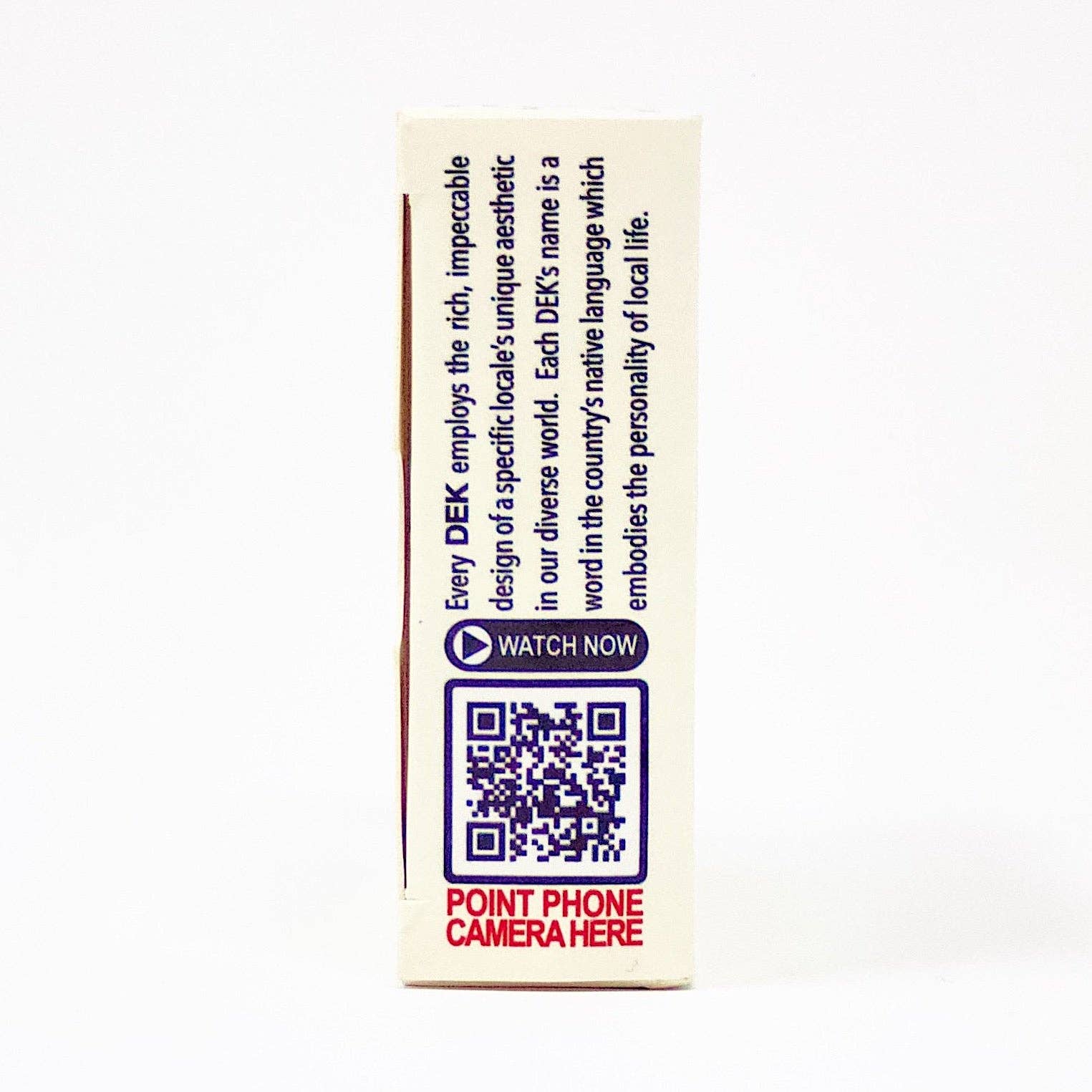 The side of the package for the Playing Cards: DEK Lagom (Sweden) features a QR code with bold text that says WATCH NOW, encouraging you to scan it with your phone camera. Discover DEK's distinctive aesthetic, which effortlessly integrates local culture and the art of balanced living, capturing the essence of Lagom.