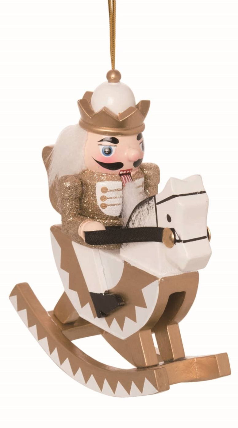 The Ornament: Wood Rocking Horse Nutcracker Ornament – 5 Holiday Decor features a gold and white nutcracker on a matching horse, suspended by a gold string—a festive touch inspired by classic European tradition.