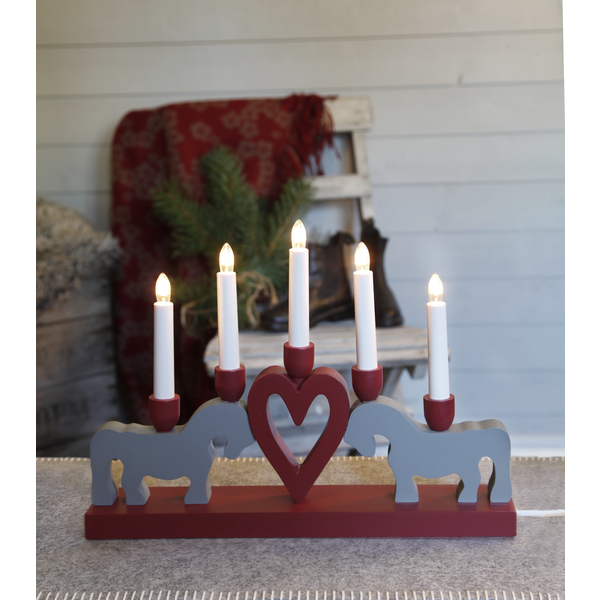 The "Leksand Candlestick" by Star Trading features five LED candle sticks with two gray Swedish Dala Horses and a red heart, creating a charming wooden candelabra centerpiece.
