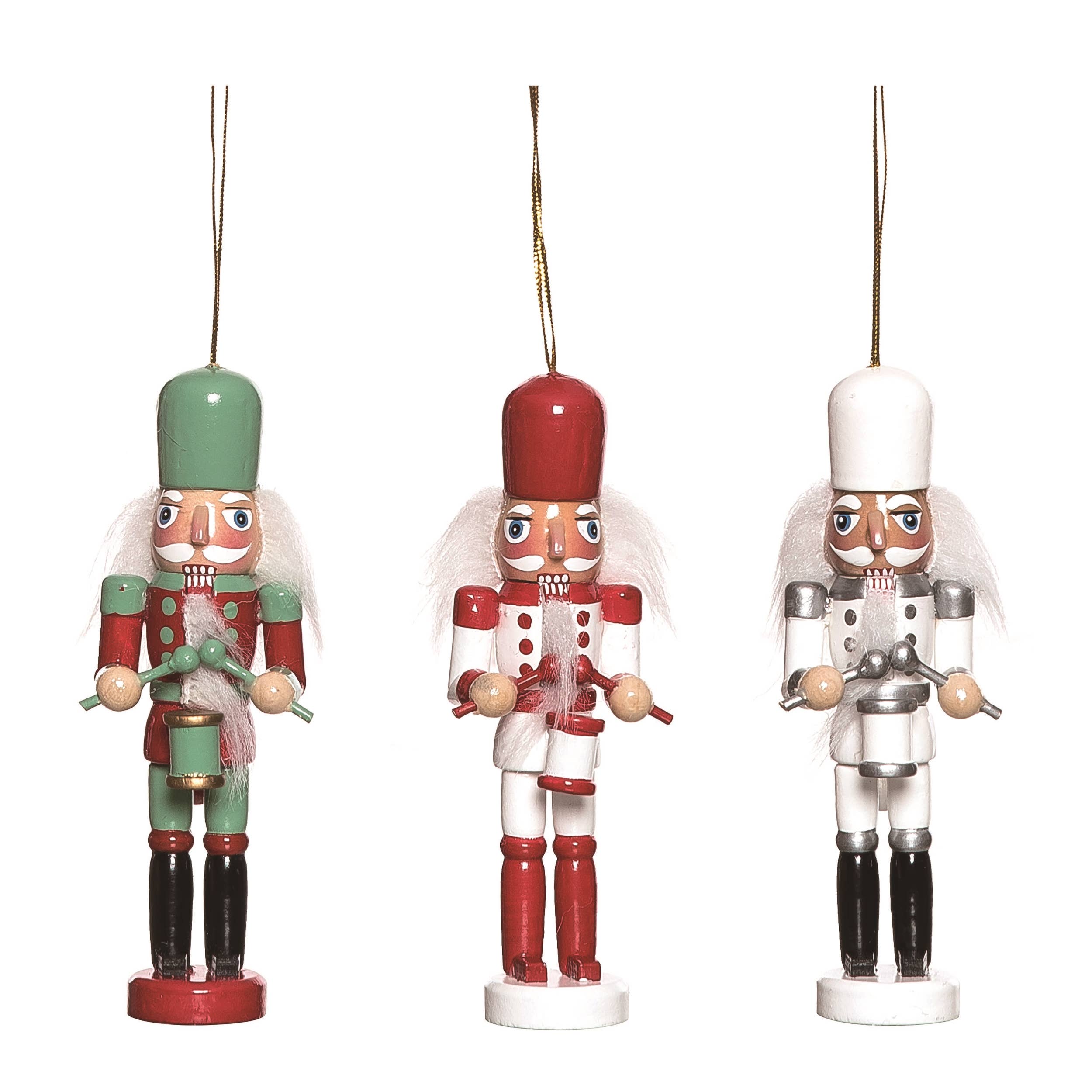 Three 5 tall Nutcracker Christmas Wood Retro Ornaments in green, red, and white uniforms with gold hanging strings are displayed side by side.
