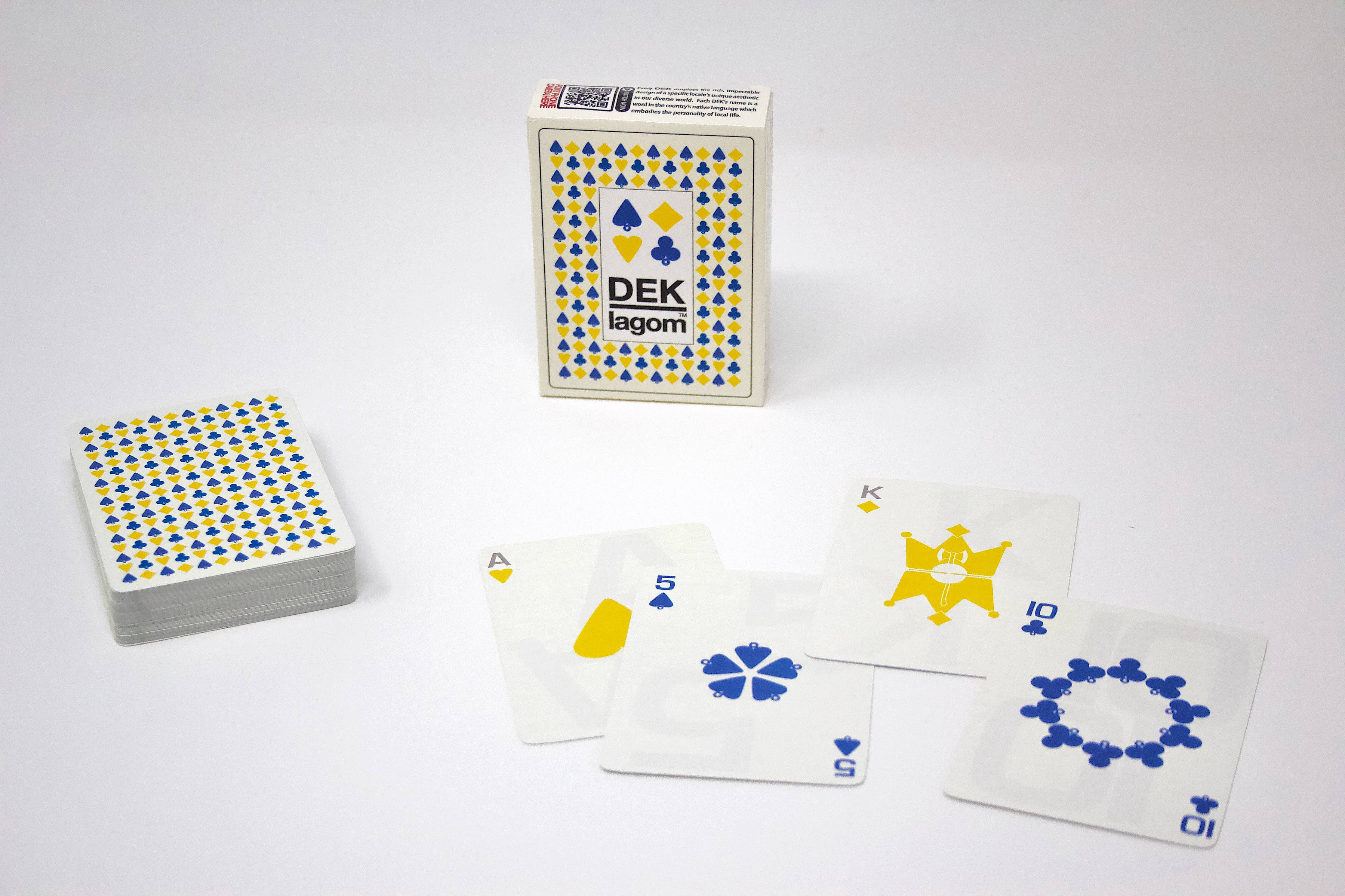 The DEK Lagom playing cards from Sweden capture the essence of balanced living, showcasing four distinct cards in a spread: ace, king, ten, and five from various suits.