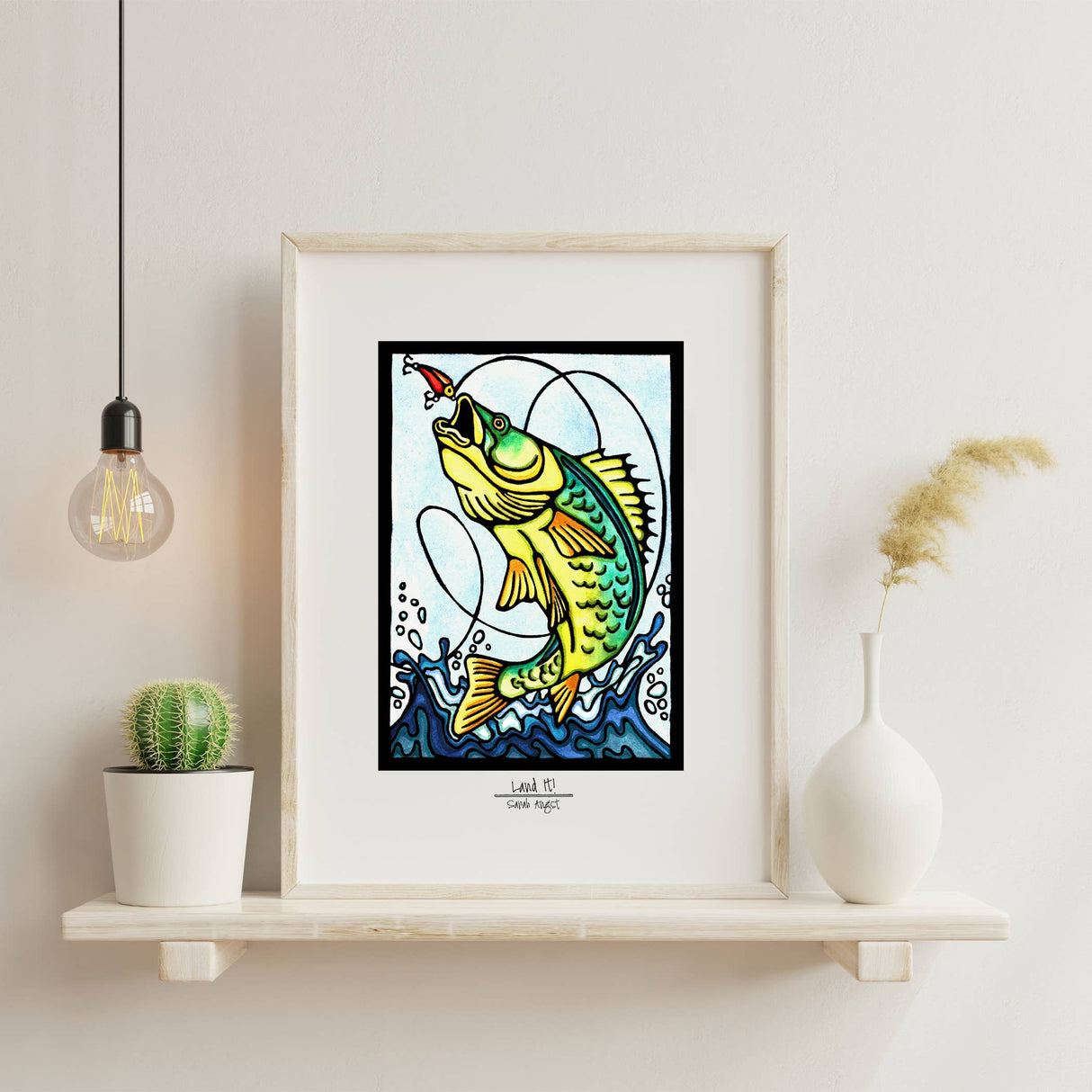 The Land It by Sarah Angst is an 11x14 giclee print with a white mat border, featuring a yellow fish and red lure—ideal lake life decor for your shelf alongside plants, vases, and modern accents.