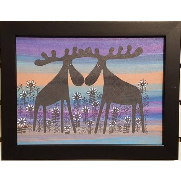 The framed 11x14 artwork, Moose Couple, Alfred & Anna in a Flower Bed Orange, features two stylized moose among white and purple flowers with a striped purple, blue, and orange background—ideal for Scandinavian decor.