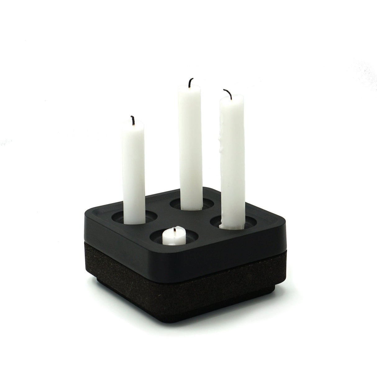 The Stumpastaken Fyran Four Candle Holder is a square, white powder-coated piece made from 100% recycled aluminum. Its classic Swedish design holds four candles of varying heights for timeless, sustainable interior decor.