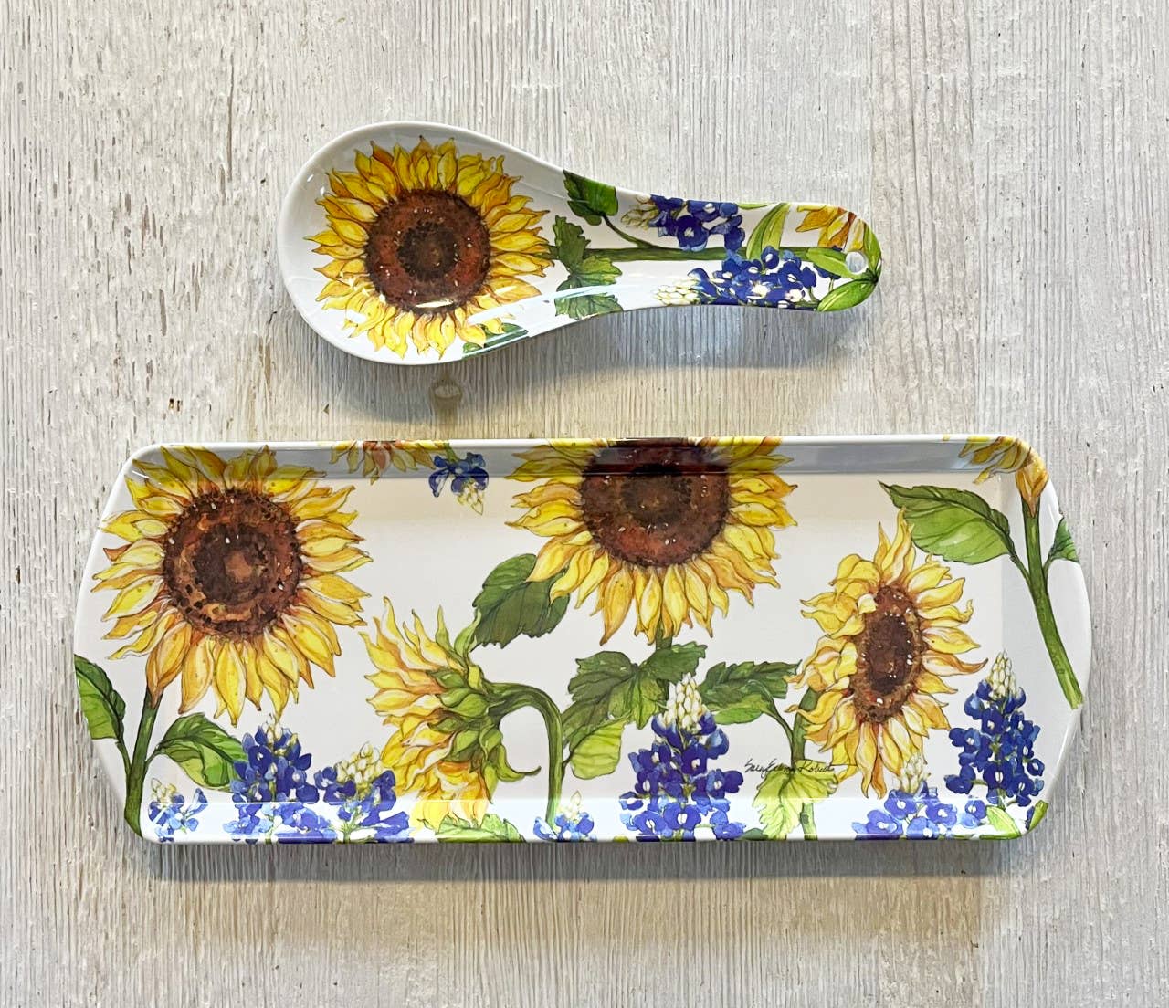 The Sunflower & Bluebonnets Floral Loaf Serving Charcuterie Tray, featuring vibrant botanical patterns, rests on a light wooden surface—making it an eco-friendly and stylish choice for your next gathering.