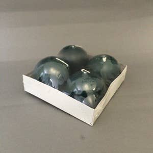 A white square tray displays four 2.5" Pine Green Ball Candles, each burning for 8 hours, arranged in a 2x2 formation against a plain gray background.
